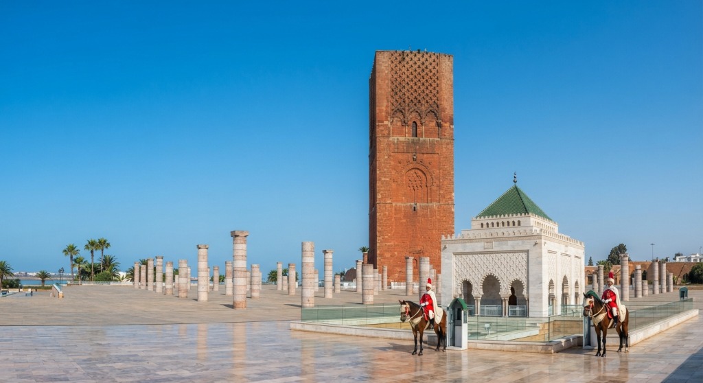 Hassan Tower minaret and Royal Mausoleum of Mohammed V with mounted guards